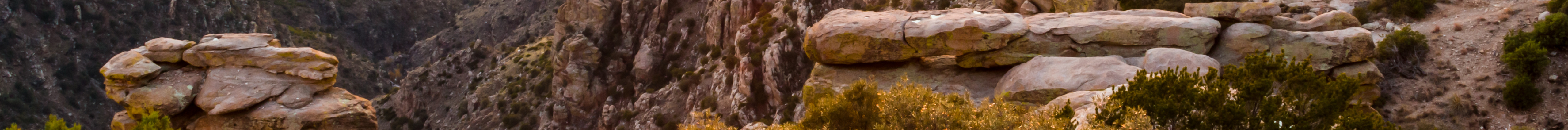 Rock formations rising above the desert landscape.