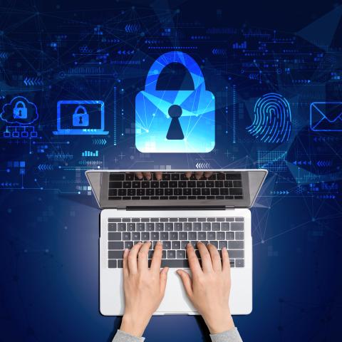 Hands typing on a laptop with cybersecurity icons and a digital network background.